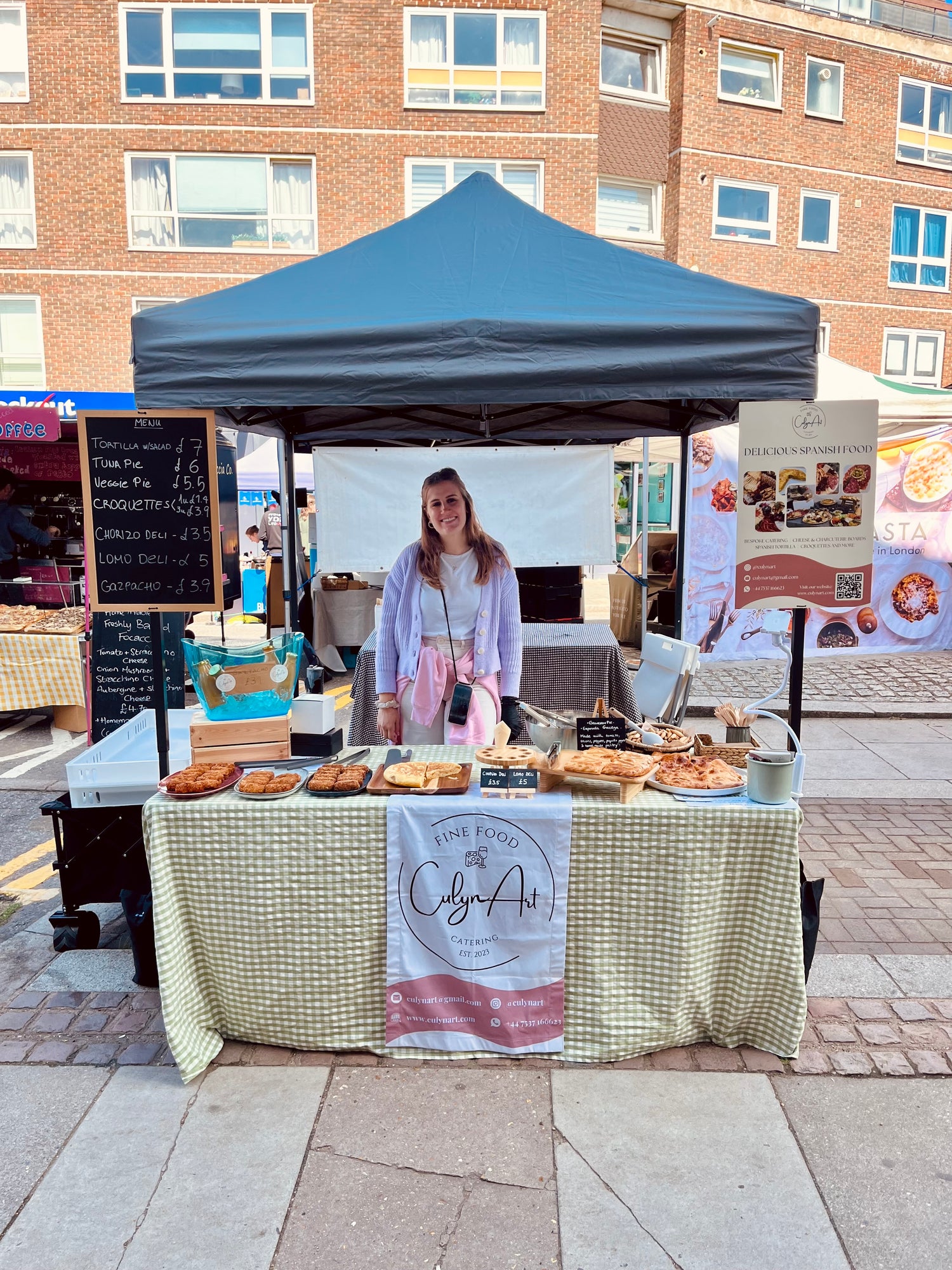 Culynart Stall in a Street Food Marketing featuring spanish tapas products in display as well as the owner, Aixa Fernandez